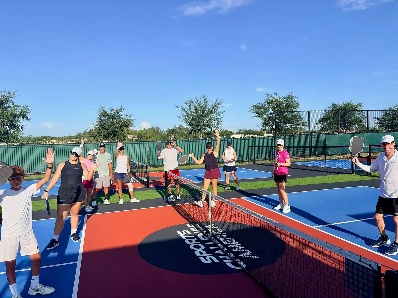 A UPA clinic group celebrating together at the net